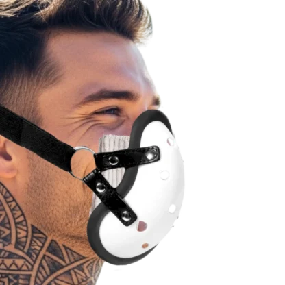Image of male with neck tattoos, with face strap in shape of groin cup.