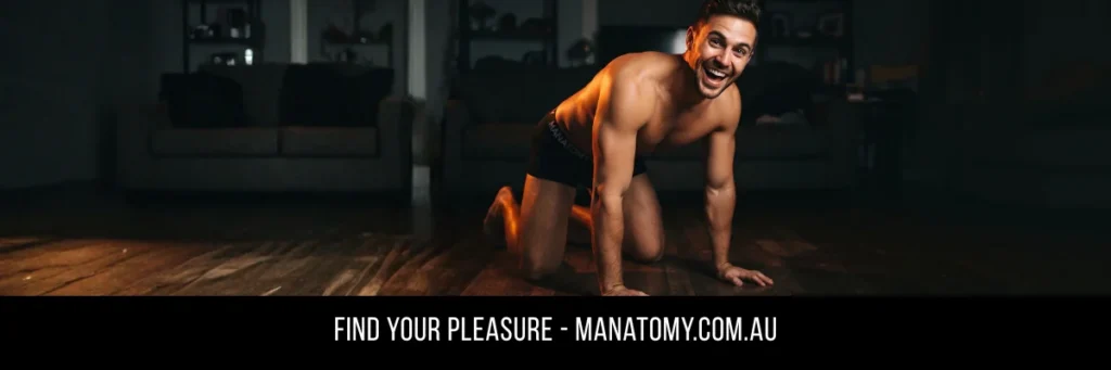 A grinning man on all fours on a dark timber floor in front of a couch, above a Find Your Pleasure banner.