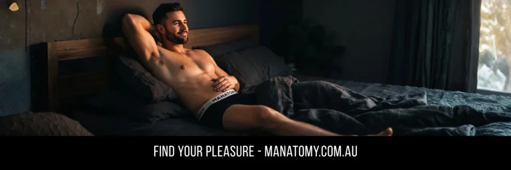 A man stretched out on a dark bed with one arm behind his head, above a Find Your Pleasure banner.